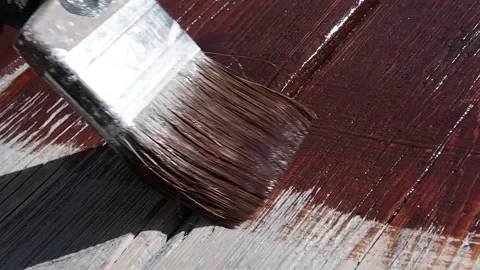 Paint old boards with a brush with brown paint. Video stock 133080992
