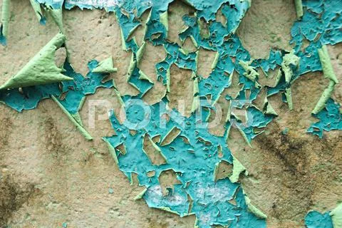 Paint is peeling off, weather-beaten wall. Stock Photos