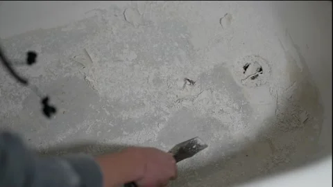 Paint removed scraped off  from old bath tub Stock Footage 162146199