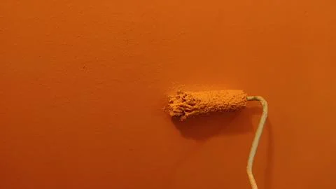 A paint roller against the wall 写真素材