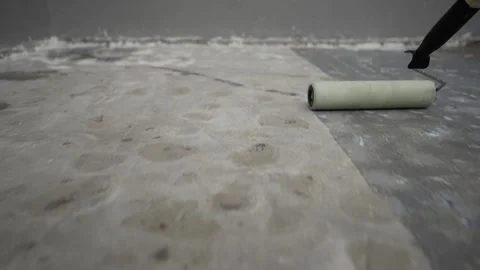 Paint roller applying primer on concrete floor Stock Footage 342347850