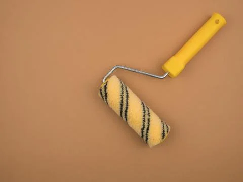 Paint roller on beige background. Construction tool. Stock Illustration