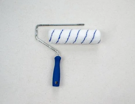 Paint roller with blue handle and velour nozzle isolated on light background Stock Photos