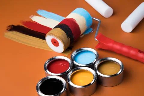 Paint roller, cans with color Free Stock Photos