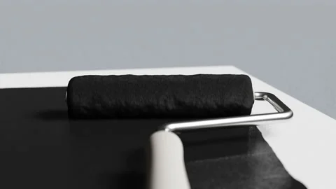 The paint roller covers the light surface in a dark color Stock Footage 165651807