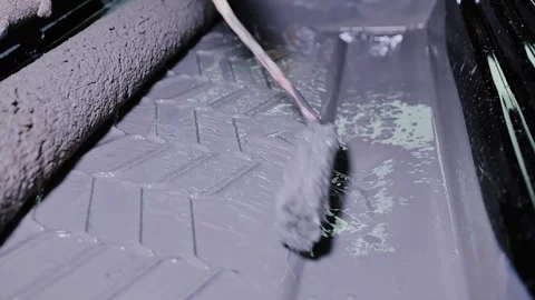 Paint Roller Dipped In Thick Gray Paint On Textured Tray Under Workshop Light Stock Footage 320097235