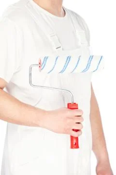 Paint roller in hand of a worker Stock Photos
