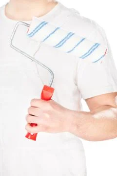 Paint roller in hand of a worker Stock Photos
