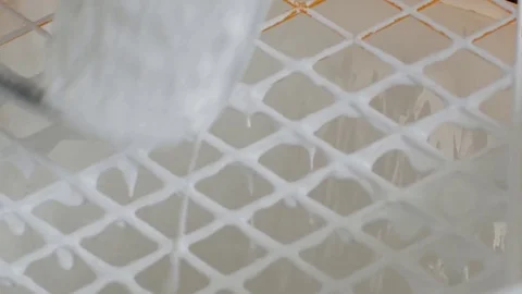 The paint roller immersing in a bucket with white paint Stock-Footage 84885884
