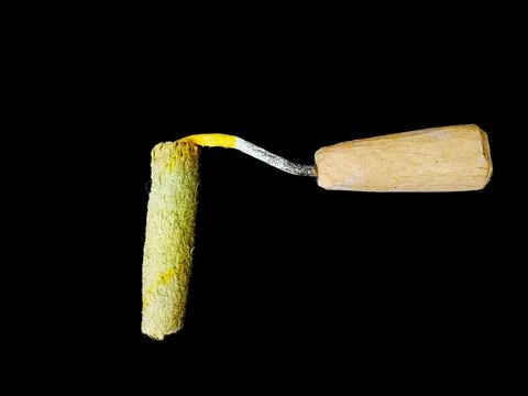 Paint roller isolated on a black background. Painting tool for painting. Stock Photos