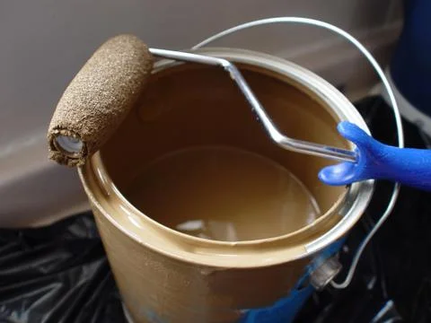 Paint roller on paint can Stock Photos