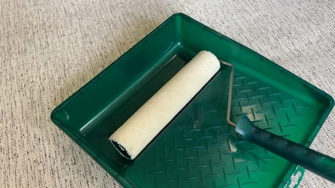 Paint roller with paint in container room. Stock Footage 270309142