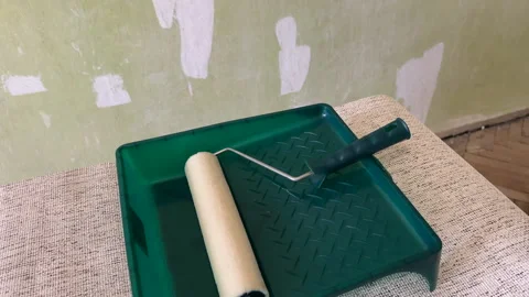 Paint roller with paint in container room. Painting the walls Stock Footage 270309146