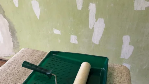 Paint roller with paint in container room. Painting the walls Stock Footage 270309212