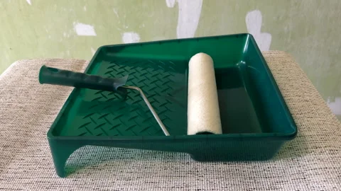 Paint roller with paint in container room. Stock Footage 270309245
