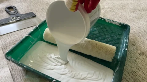 Paint roller with paint in container room. Painting the walls Stock Footage 273109949