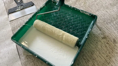 Paint roller with paint in container room. Painting the walls in a room 스톡 동영상 273110394