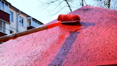 Paint roller painting elements of the playground in red Stock Footage 129094989