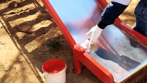 Paint roller painting elements of the playground in red Stock Footage 129095072