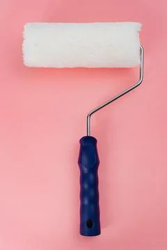 Paint roller on a pink background Stock Photos