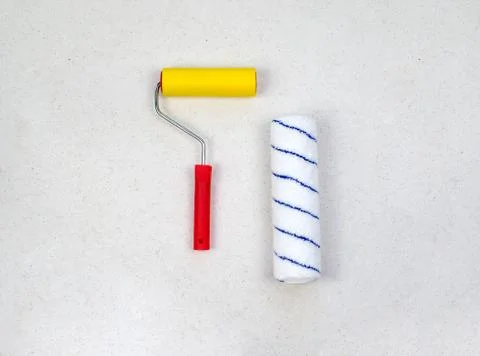 Paint roller with red handle, yellow smooth and soft velou nozzles isolated o Stock Photos