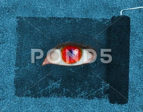 Paint roller revealing a red eye Stock Photos