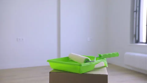 The paint roller storage box is unveiled in the new room. Stock Footage 313679586