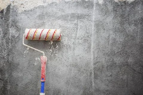 Paint roller on wall Stock Photos