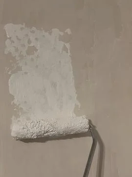 Paint Roller on Wall – Renovation Process Stock Photos