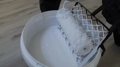 Paint roller in white paint bucket Stock Footage 335042746