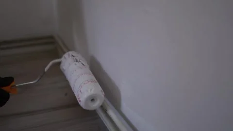 Paint roller on white wall Stock Footage 335040846