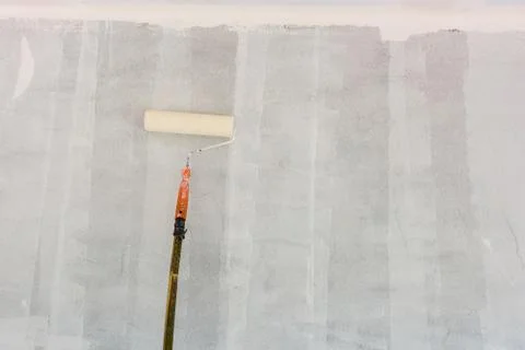 Paint Roller on white wall Fotos Stock