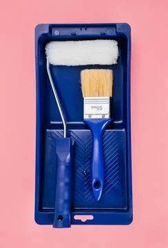 Paint rollers and brushes in a special bath or ditch. Stock Photos