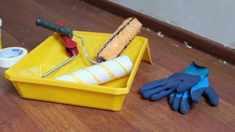 Paint rollers, protective gloves, paint trough and masking tape. Stock Footage 238755143
