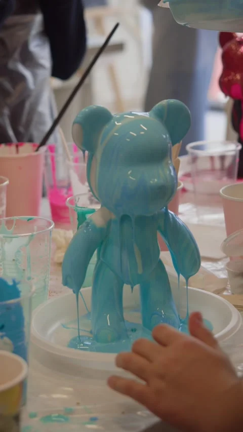 Paint runs down the new toys the artist makes in his studio. They are in the Stock Footage 306589348