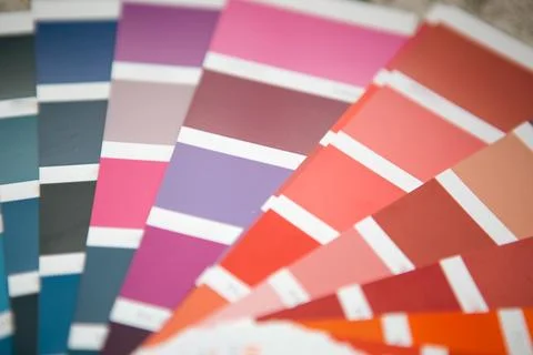 Paint sample fan deck with pink, purple, and blue swatches, color selection.. Stock Photos