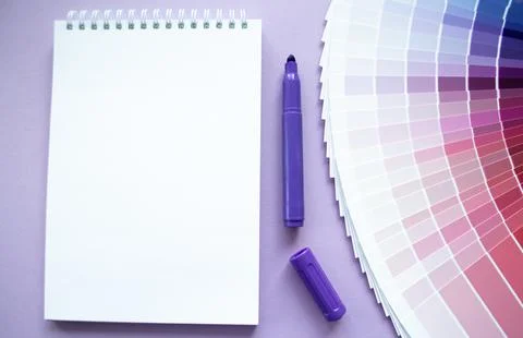 Paint samples, multicolors swatch. Lilac background, notebook, purple marker Stock Photos