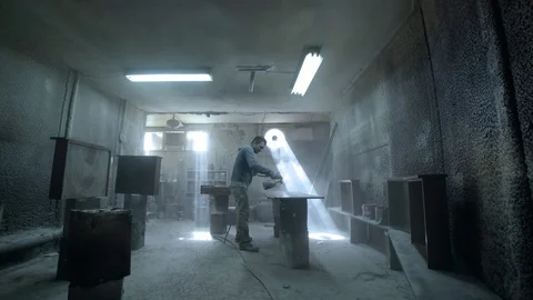 Paint-spraying gun used by a worker to color furniture Stock Footage 122029092