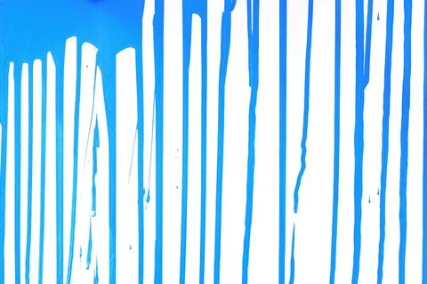 Paint streams on a  light  blue surface. A background with strips from colo.. Stock Photos