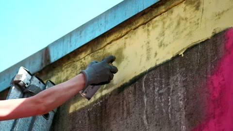 Paint the wall of a can of yellow paint Stock Footage 155078769