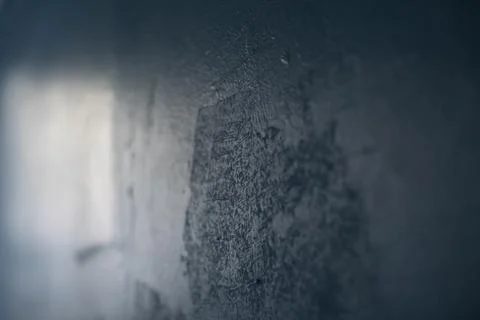Paint on wall. Light on blue wall. Badly made wall. Stock Photos