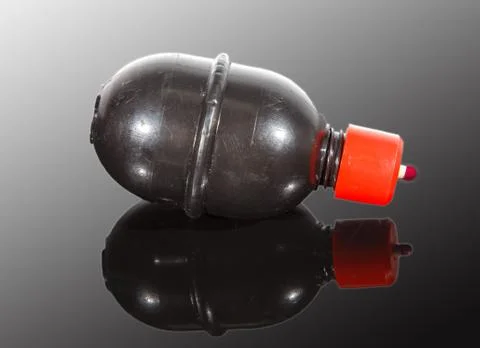 Paintball grenade on reflective surface Stock Photos