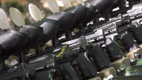 Paintball guns in a row. Charging weapons. Stock Footage 109909523
