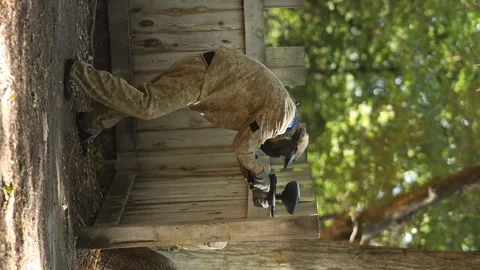 Paintball player in protective mask aims gun, takes cover under fire Stock Footage 289405979