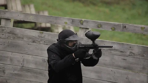 Paintball player shoots the enemy with a marker Stock Footage 101712353