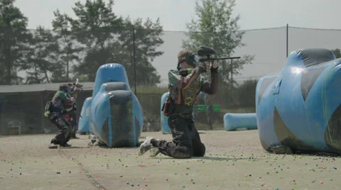 Paintballplayer on the Field while a Battle is going on Stock Footage 66439837