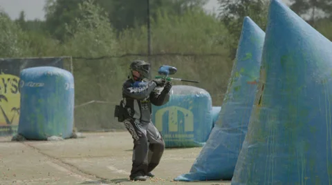 Paintballplayer on the Field while a Battle is going on Stock Footage 66446342