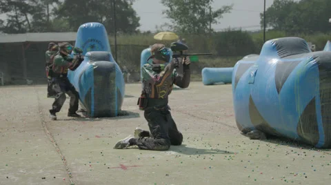Paintballplayer on the Field while a Battle is going on in 4K Stock Footage 66453887