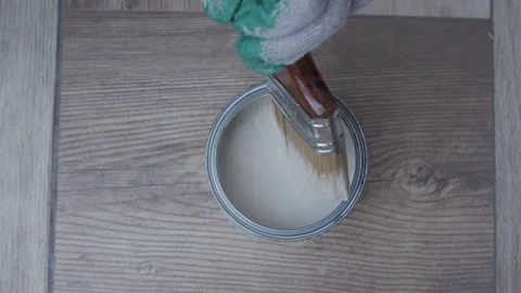 Paintbrush and dipping it into white paint. Stock Footage 333320321