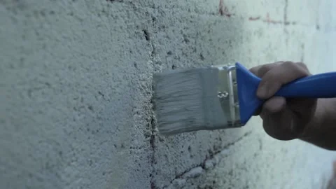 Paintbrush on the cracks of the wall Stock Footage 142957705